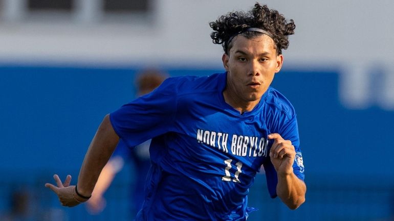 Steven Vargas of North Babylon looks to drive through the...