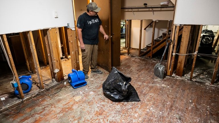 Jason Nardi spent much of the day removing wet drywall...