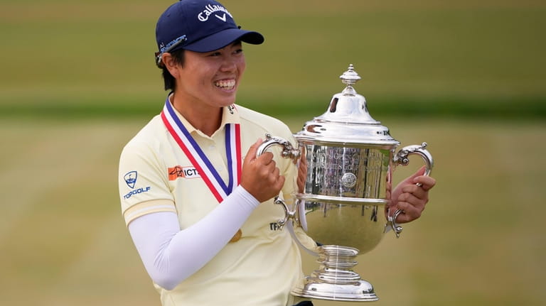 Yuka Saso, of Japan, holds the tournament trophy after winning...