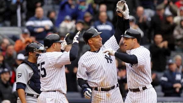 Mark Teixeira #25 celebrates with Derek Jeter #2 and Russell...