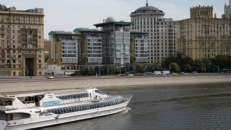 A boats floats past the British Embassy building, center, in...