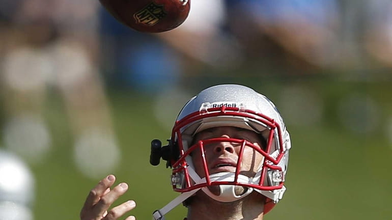 New England Patriots quarterback Tim Tebow tosses a ball during...