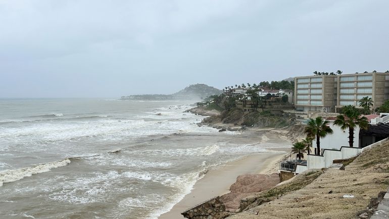 Hotels stand along the shore before the arrival of Tropical...