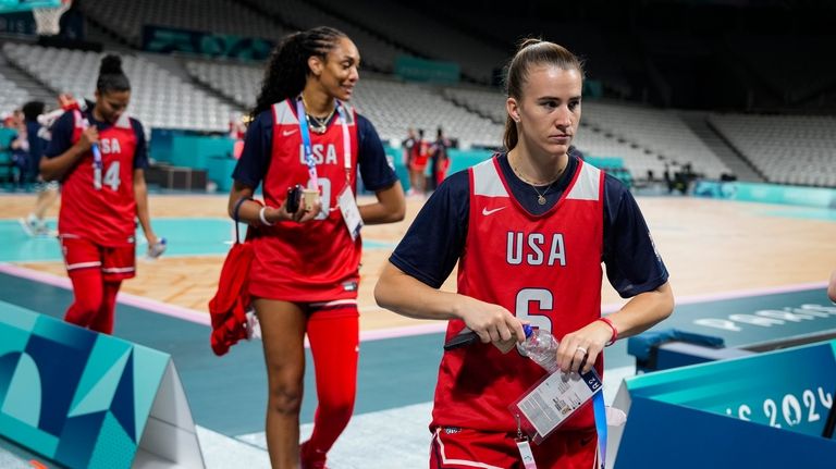 Sabrina Ionescu (6), A'ja Wilson (9) and Alyssa Thomas, walk...