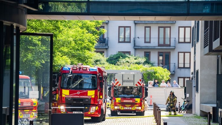 Firefighters work to extinguish a fire at the building housing...