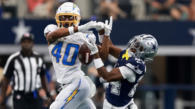 Dallas Cowboys safety Israel Mukuamu, right, breaks up a pass...