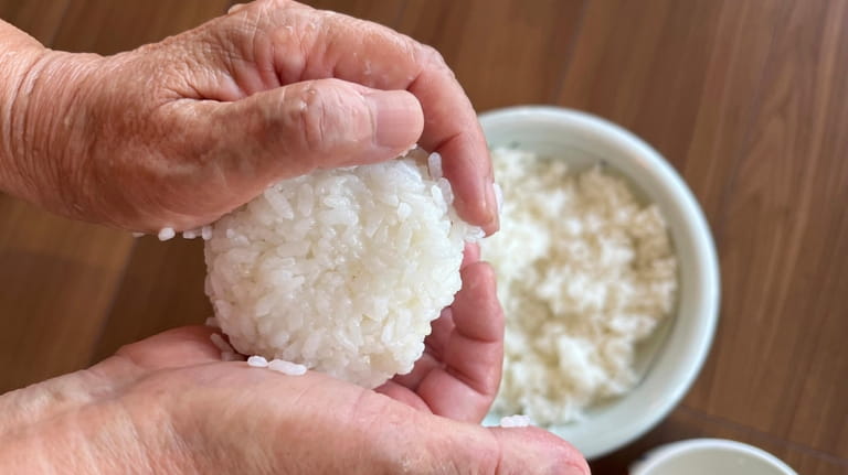 A rice ball is made in Tokyo, on June 14,...