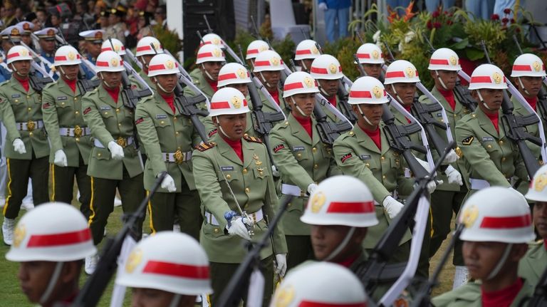 Soldiers march before the start of a ceremony marking Indonesia's...