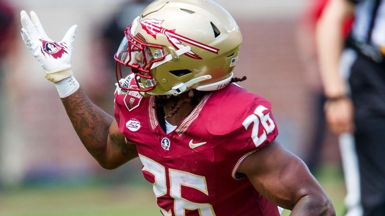 Florida State running back Caziah Holmes (26) juggles a pass...