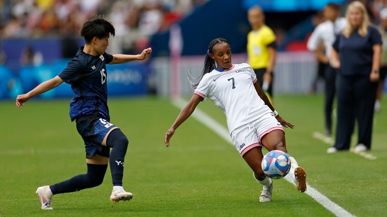 Crystal Dunn of the United States, right, is approached by...