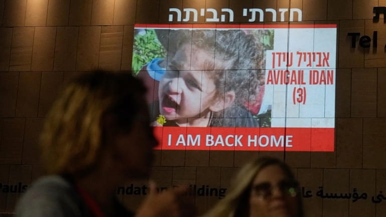 People walk past an image of 4-year-old Abigail Edan, a...