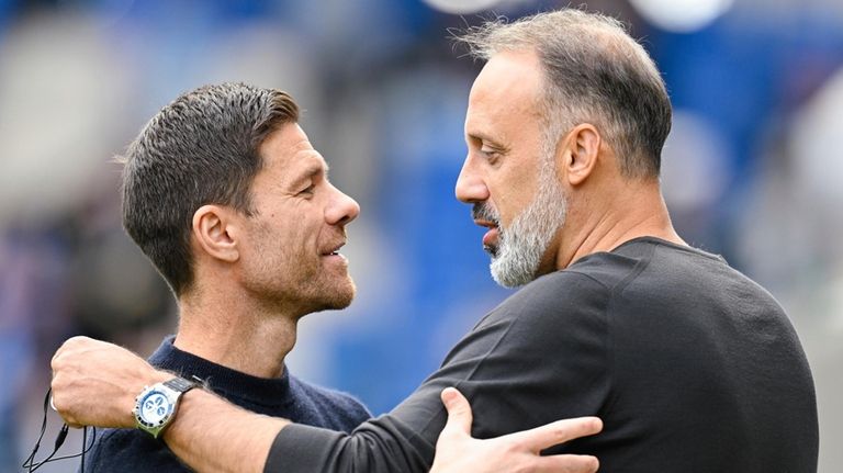 Hoffenheim coach Pellegrino Matarazzo, right, and Leverkusen's head coach Xabi...