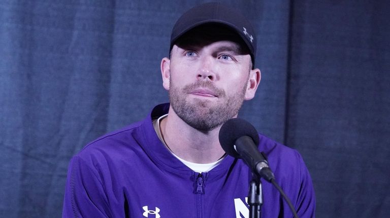 Northwestern interim head coach David Braun listens to a question...