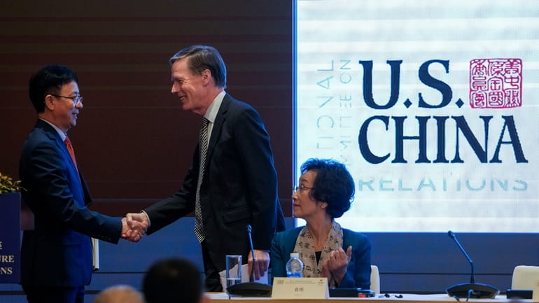 U.S. Ambassador to China Nicholas Burns, center, shakes hands with...