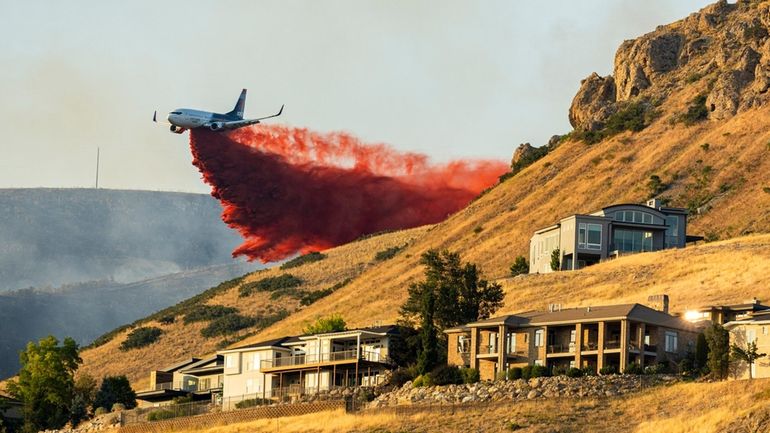 A plane drops fire retardant as the Sandhurst Fire burns...