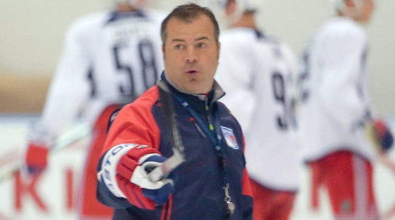New York Rangers head coach Alain Vigneault instructs his team...