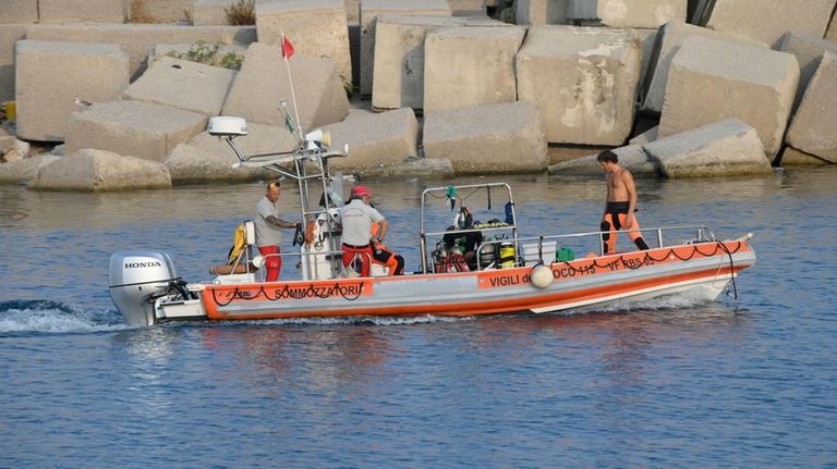 Italian Firefighters scubadivers sails towards the area where the UK...