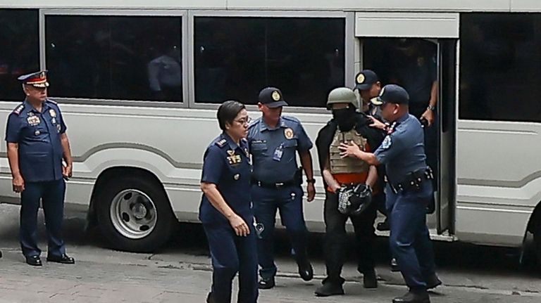 Apollo Carreon Quiboloy, wearing a helmet and flak jacket, a...