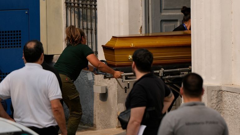 Police bring the remains of lawmaker Eulalio "Lalo" Gomez to...