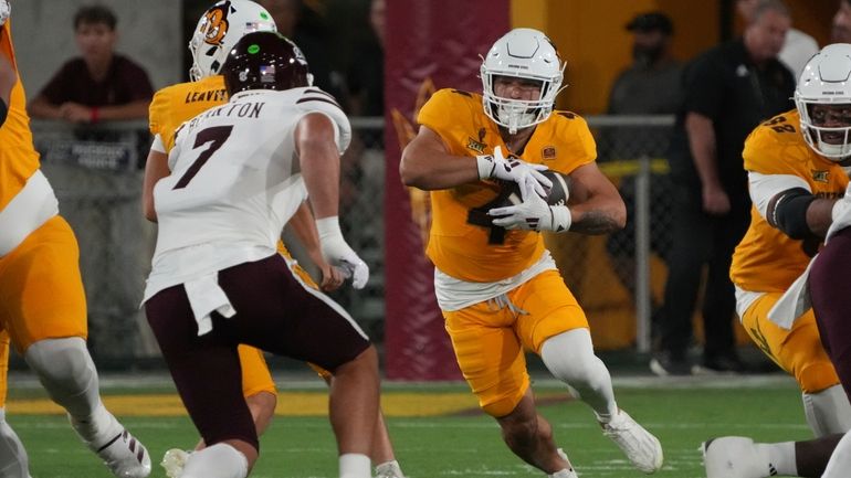 Arizona State running back Cam Skattebo (4) runs the ball...