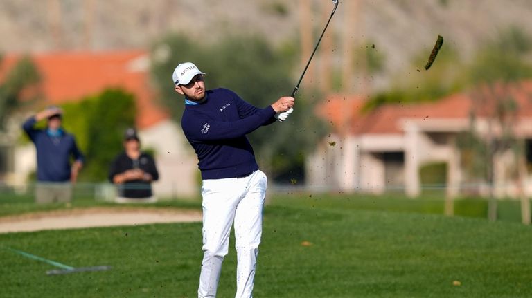 Patrick Cantlay watches his second shot on the first hole...