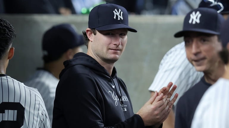 Yankees injured starting pitcher Gerrit Cole (45) in the dugout...