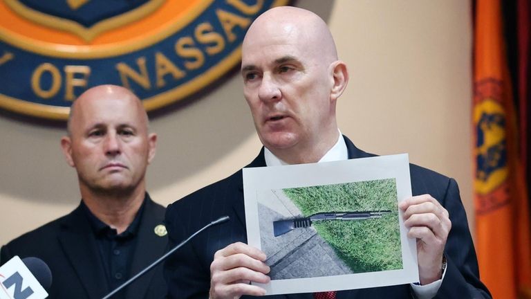 Nassau County Police Capt. Stephen Fitzpatrick holds a photograph of...