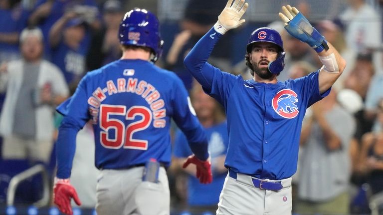 Chicago Cubs' Pete Crow-Armstrong (52) is met by Dansby Swanson...