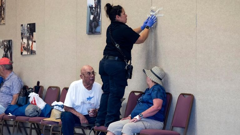 A person is treated for for heat-related illness at the...