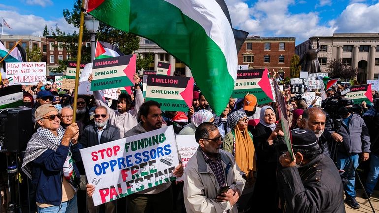 Demonstrators rally in front of the Theodore Roosevelt Executive and Legislative...