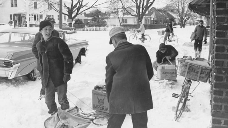 Newsday carriers prepare to deliver the paper through the snow...
