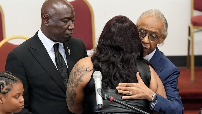 Rev. Al Sharpton hugs DeAsia Harmon at the funeral for...