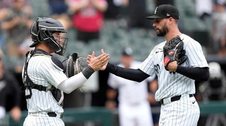 Chicago White Sox catcher Korey Lee and relief pitcher Justin...
