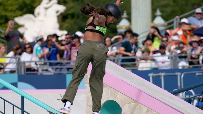 Rayssa Leal, of Brazil, executes a trick on the rail...