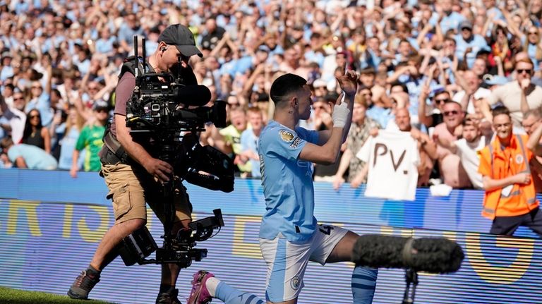 Manchester City's Phil Foden celebrates after scoring his side's opening...