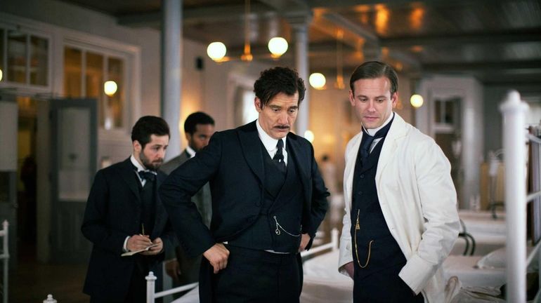 Clive Owen, left, and Eric Johnson in a scene from...