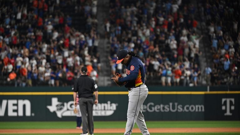 Houston Astros Framber Valdez lowers his head after giving up...