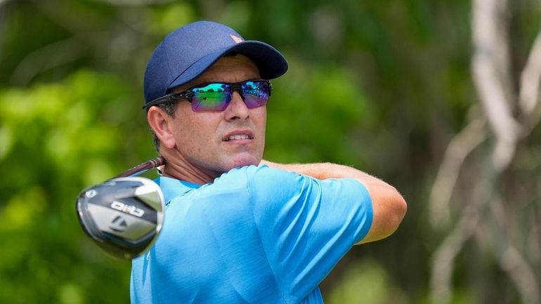 Adam Scott, of Australia, watches his tee shot on the...