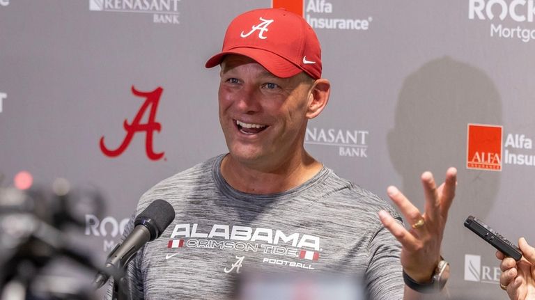 Alabama head coach Kalen DeBoer talks with the media following...