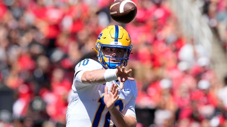 Pittsburgh quarterback Eli Holstein throws during the first half of...