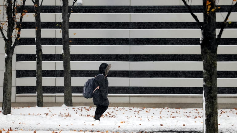 A woman walks near the Cleveland Clinic parking lot after...