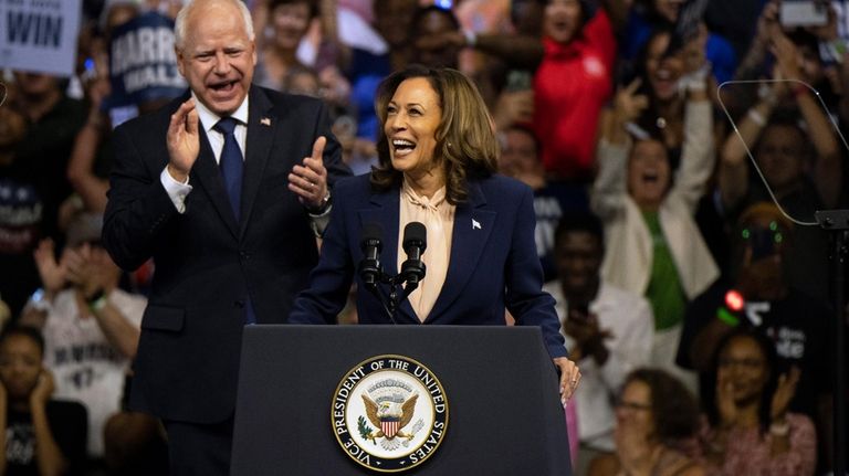 Democratic presidential nominee Vice President Kamala Harris and her running...