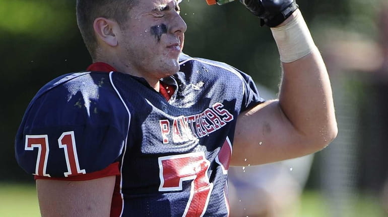 Miller Place's Chris Buchalski cools off on the sidelines against...