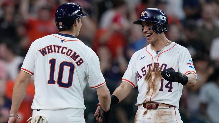 Houston Astros' Shay Whitcomb (10) and Mauricio Dubón (14) celebrate...