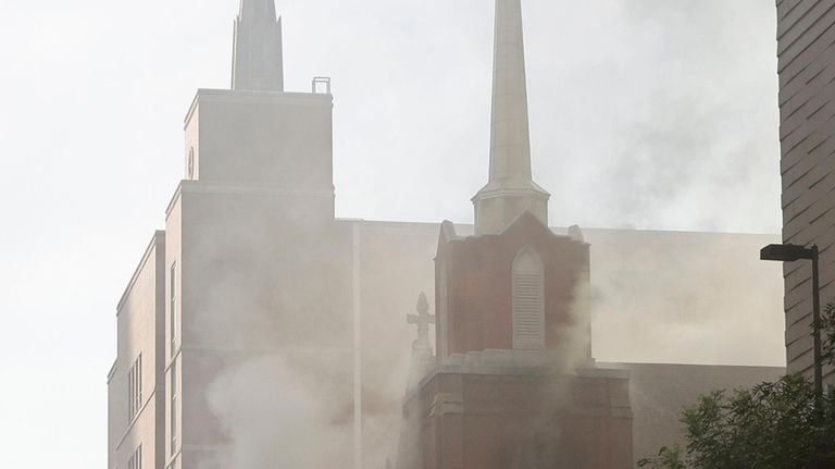 Firefighters work at the scene of a fire at First...