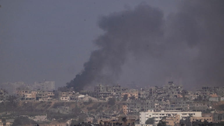 Smoke rises after an explosion in the Gaza Strip, as...