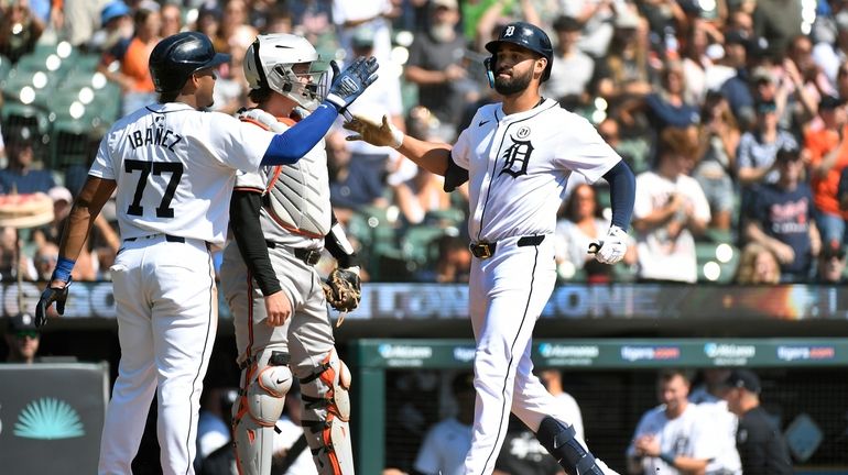 Detroit Tigers' Riley Greene, right, is congratulated by Andy Ibáñez...