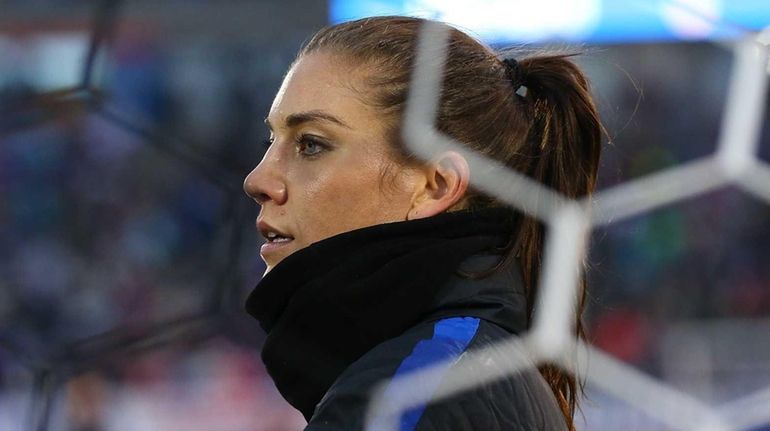 Hope Solo #1 of United States of America gets into...