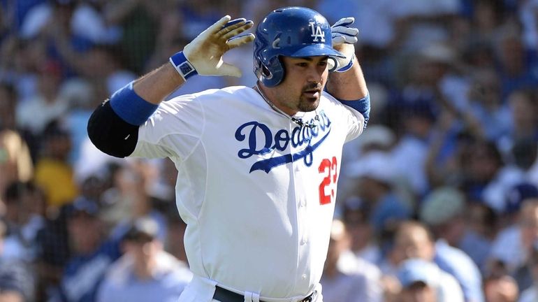 Adrian Gonzalez of the Los Angeles Dodgers reacts after he...