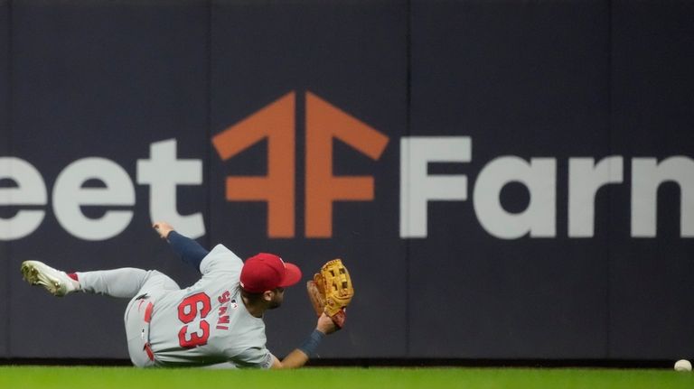 St. Louis Cardinals' Michael Siani can't catch a ball hit...